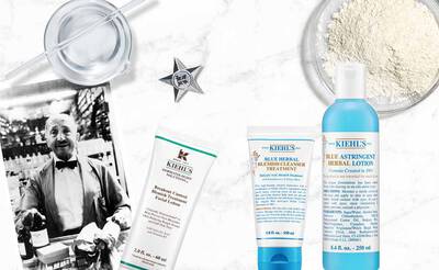 Kiehl's Produkte: Gesichtscreme, Lotion und Reinigungsbehandlung auf einem Tisch, umgeben von historischen Bildern.