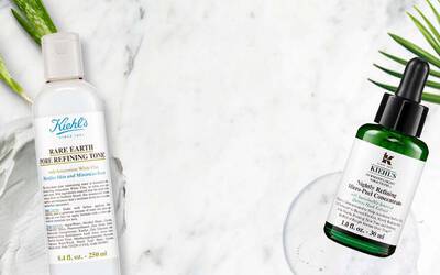 Zwei Kiehl's Hautpflegeprodukte auf marmoriertem Hintergrund: Rare Earth Pore Refining Tonic und ein Mikro-Peel-Konzentrat.