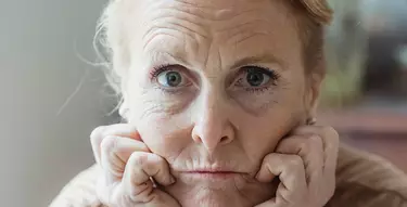 Frau mit Falten im Gesicht schaut in die Kamera