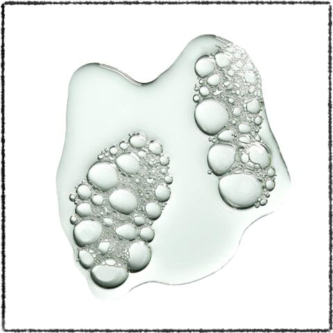 A clear, fluid shape with bubbles, resembling a puddle, featuring two distinct footprints filled with smaller bubbles.